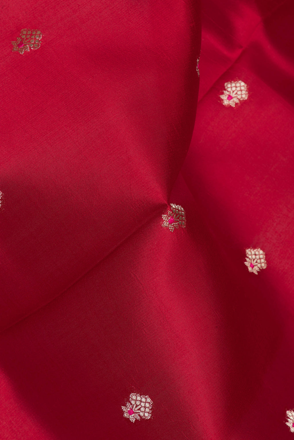 Close up of Pure Silk Red Dual Tone Tussar Saree with Zari Butta on the body and Fancy Border.  displaying folds