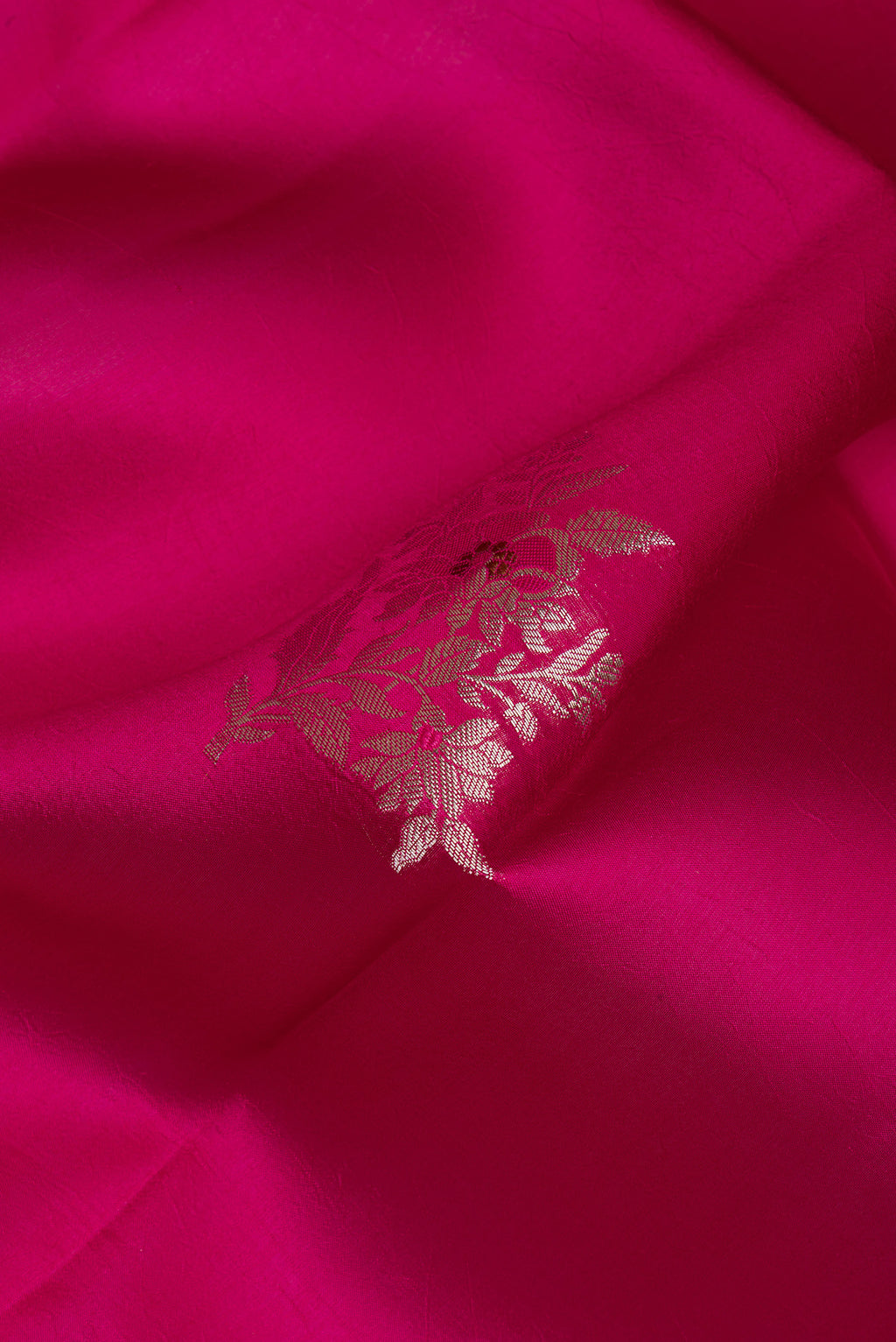 Close up of Pure Silk Dark Pink Dual Tone Tussar Saree with Zari Butta on the body and Fancy Border.  displaying folds
