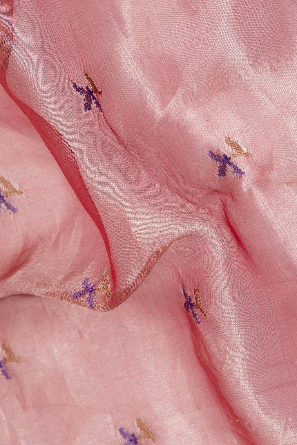 Close up of Rose Gold Organza Saree with Embroidered on the body and Fancy Border.  displaying folds