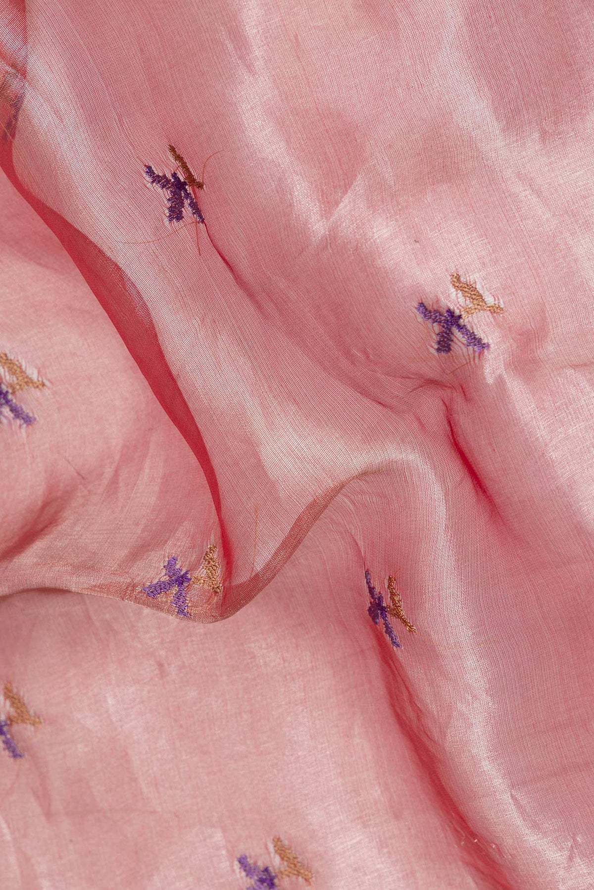 Close up of Rose Gold Organza Saree with Embroidered on the body and Fancy Border.  displaying folds