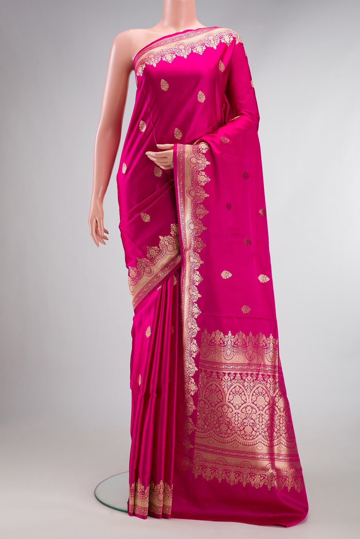 Pure Silk Pink Banarasi Saree with Zari Butta on the body and Zari Border.  displayed on a mannequin