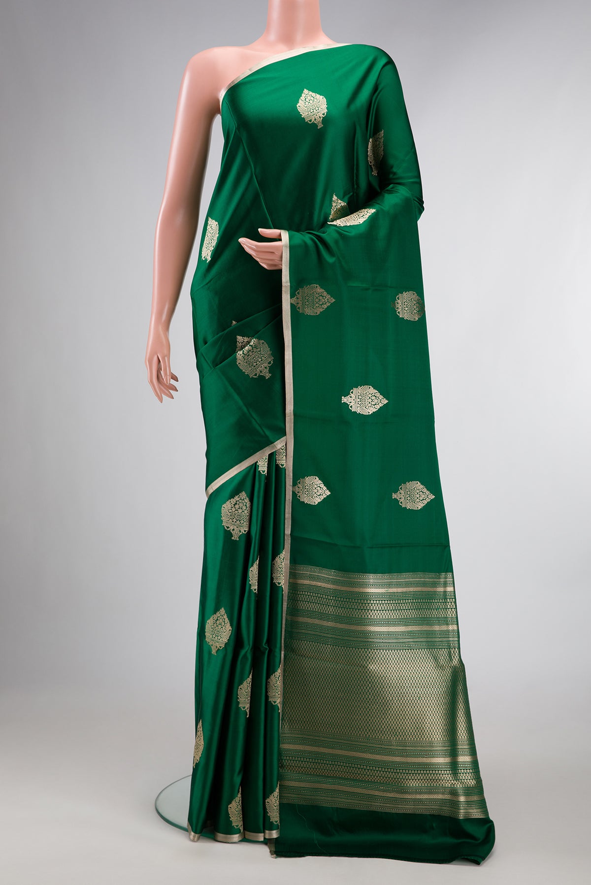 Pure Silk Green Banarasi Saree with Zari Butta on the body and Zari Border.  displayed on a mannequin