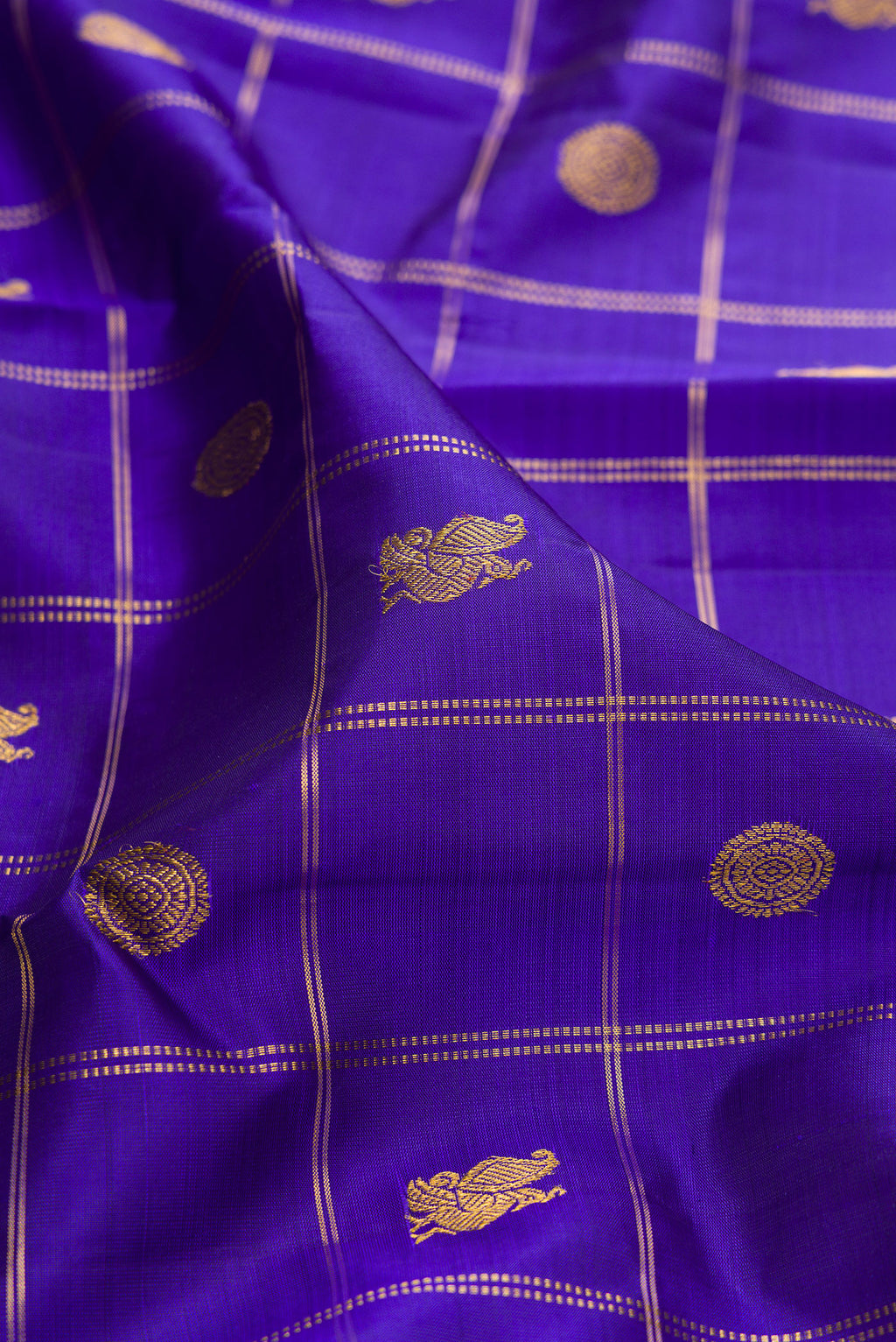 Close up of Pure Silk Dark Blue Kanjivaram Saree with Checked design on the body and Zari Border.  displaying folds