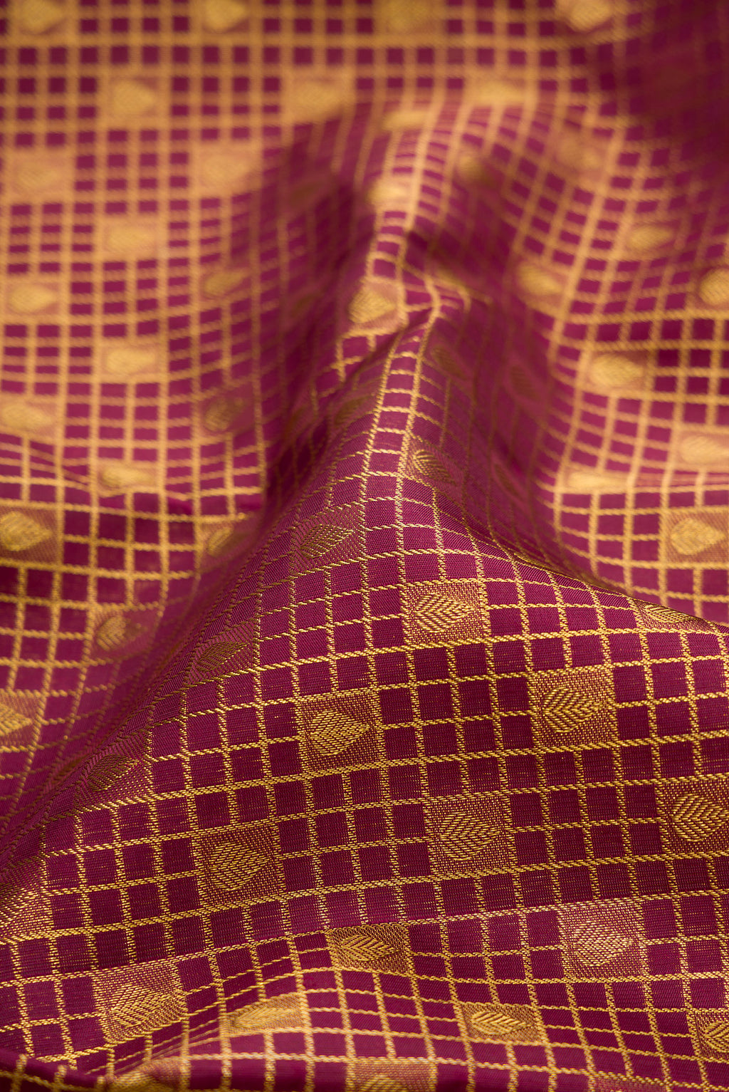 Close up of Pure Silk Maroon Dual Tone Kanchipuram Saree with Zari Brocade on the body and Zari Border.  displaying folds