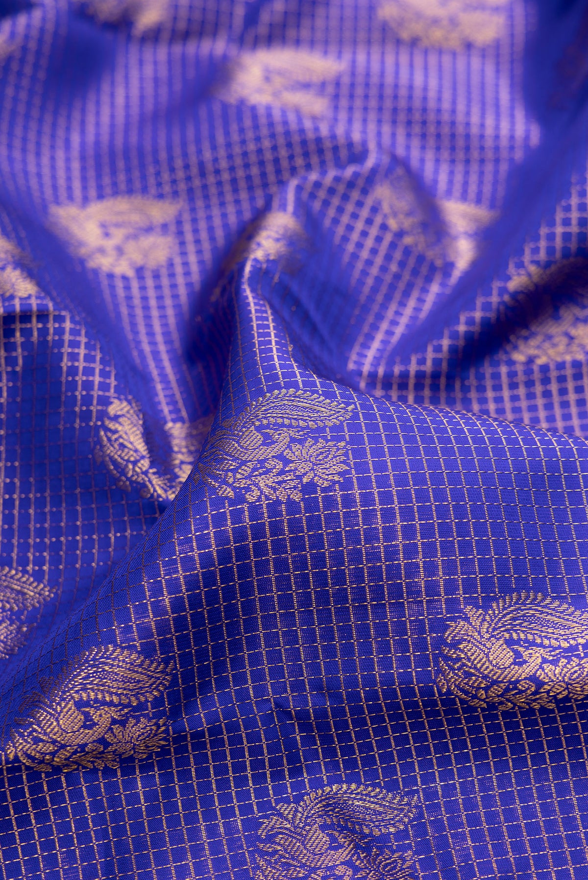 Close up of Pure Silk Royal Blue Dual Tone Kanchipuram Saree with Zari Brocade on the body and Zari Border.  displaying folds