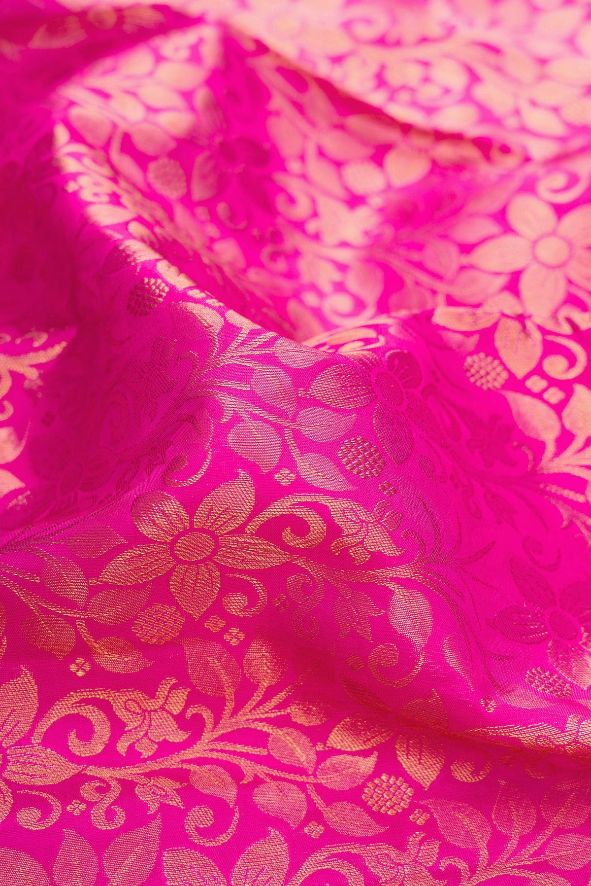 Close up of Pure Silk Pink Kanchipuram Saree with Zari Brocade on the body and Zari Border.  displaying folds