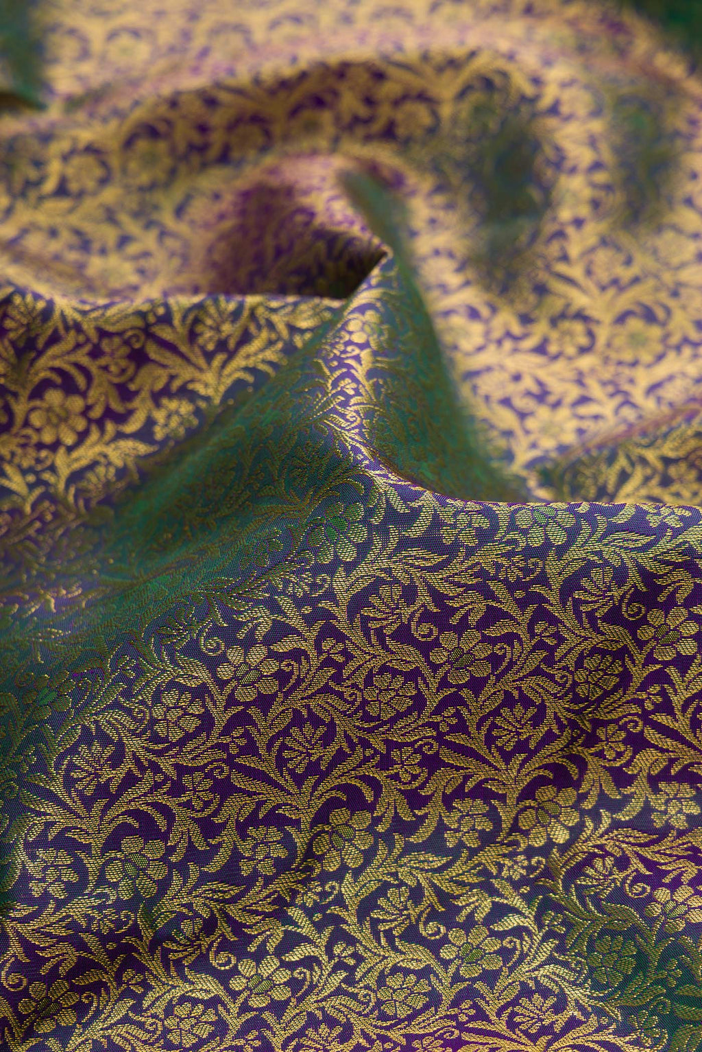 Close up of Pure Silk Green with Violet Color Kanchipuram Saree with Zari Brocade on the body and Zari Border.  displaying folds