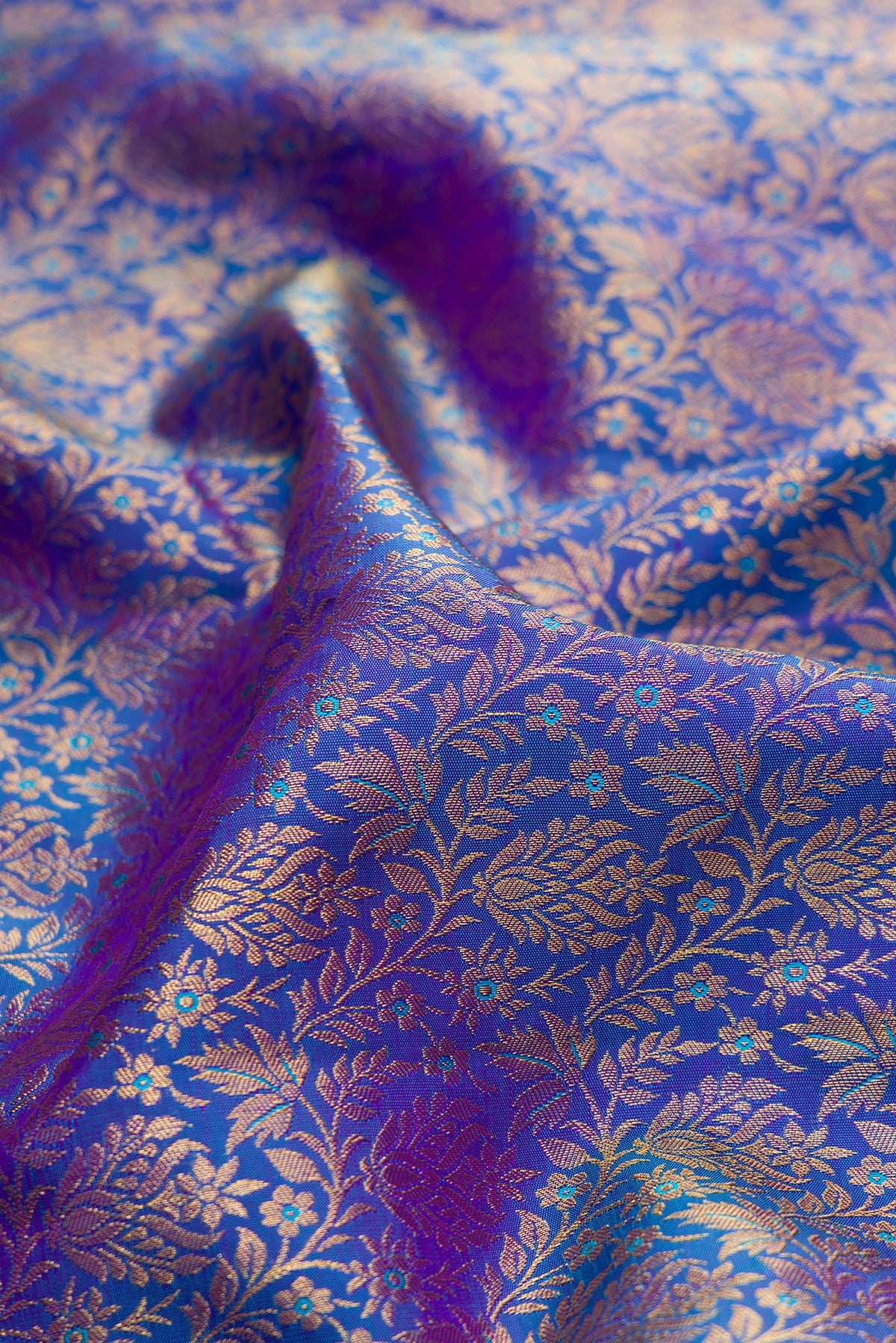 Close up of Pure Silk Royal Blue Dual Tone Kanchipuram Saree with Zari Brocade on the body and Zari Border.  displaying folds