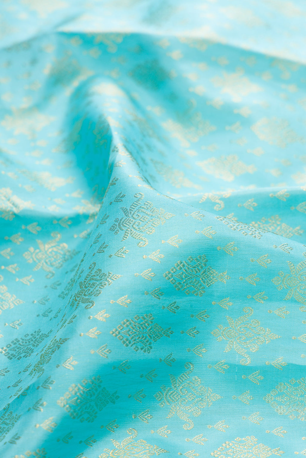 Close up of Pure Silk Sky Blue Dual Tone Kanchipuram Saree with Zari Brocade on the body and Zari Border.  displaying folds