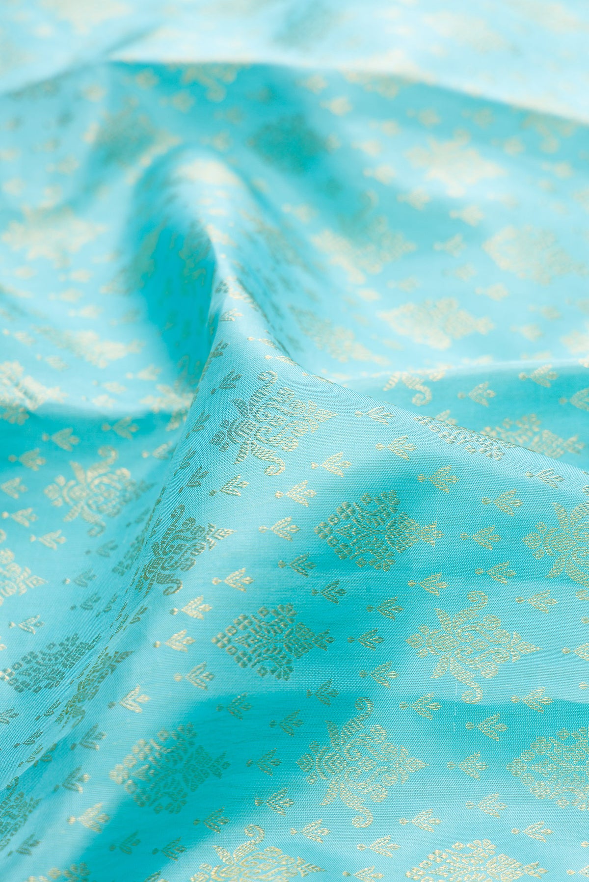 Close up of Pure Silk Sky Blue Dual Tone Kanchipuram Saree with Zari Brocade on the body and Zari Border.  displaying folds