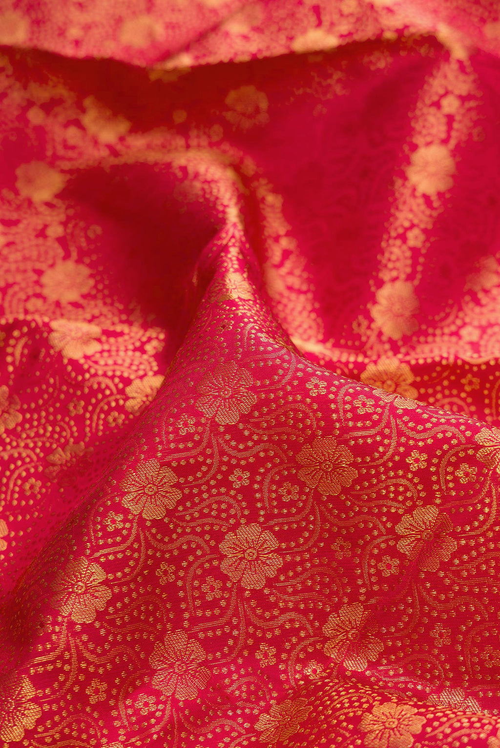 Close up of Pure Silk Red Kanchipuram Saree with Zari Brocade on the body and Zari Border.  displaying folds