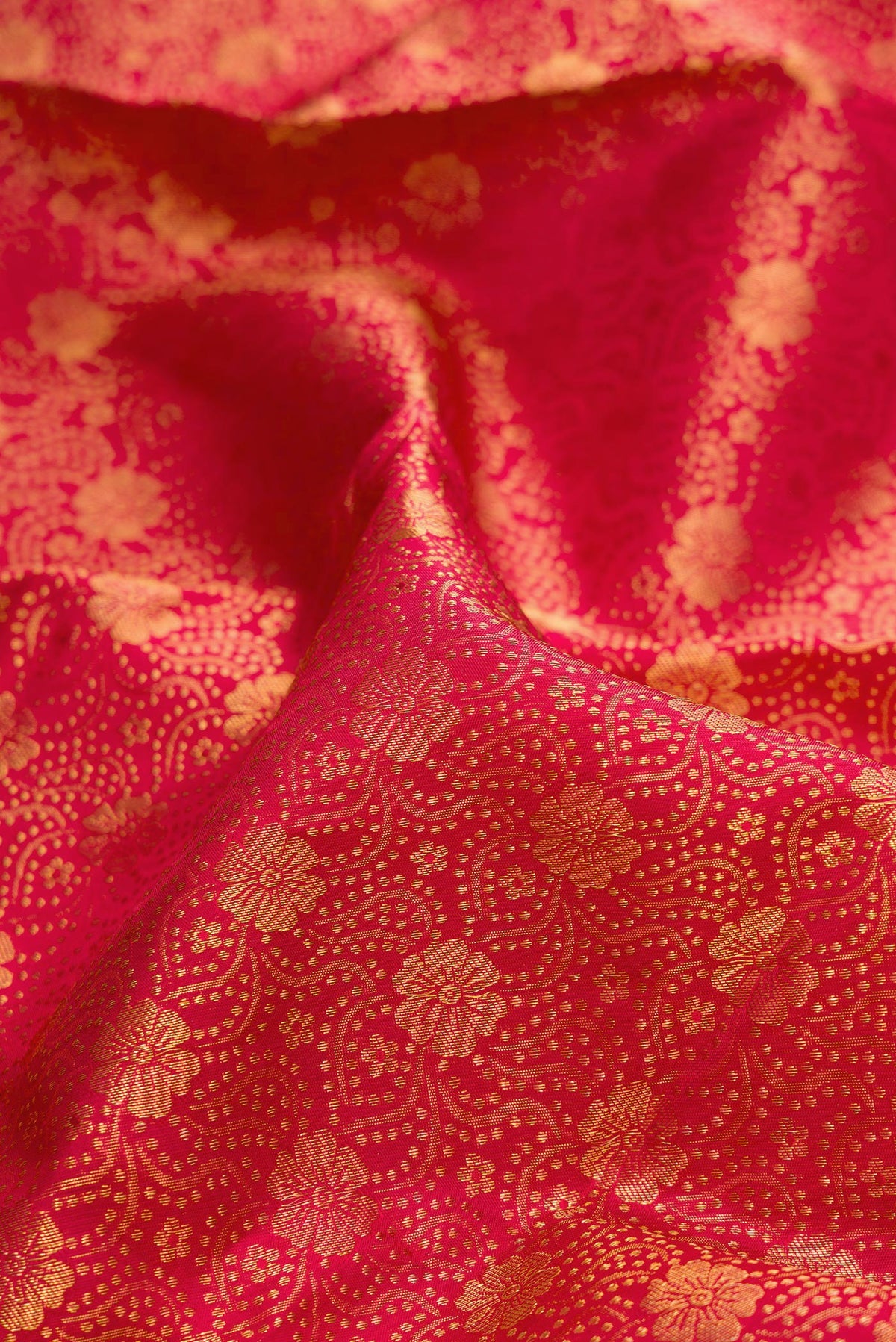 Close up of Pure Silk Red Kanchipuram Saree with Zari Brocade on the body and Zari Border.  displaying folds