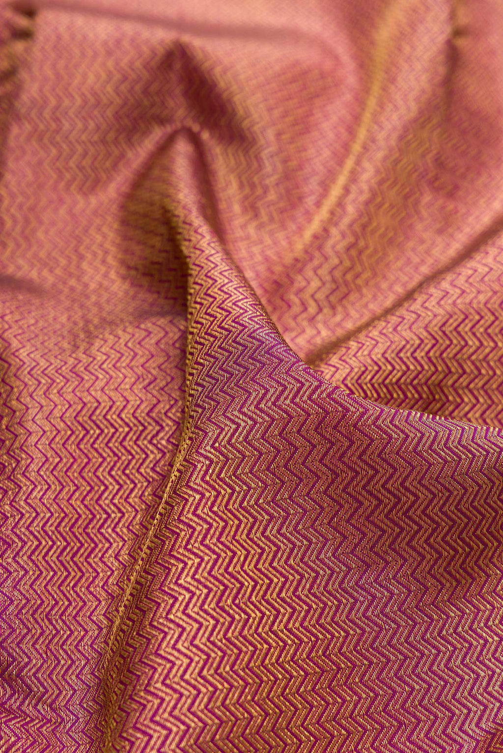 Close up of Pure Silk Magenta Kanchipuram Saree with Zari Brocade on the body and Zari Border.  displaying folds