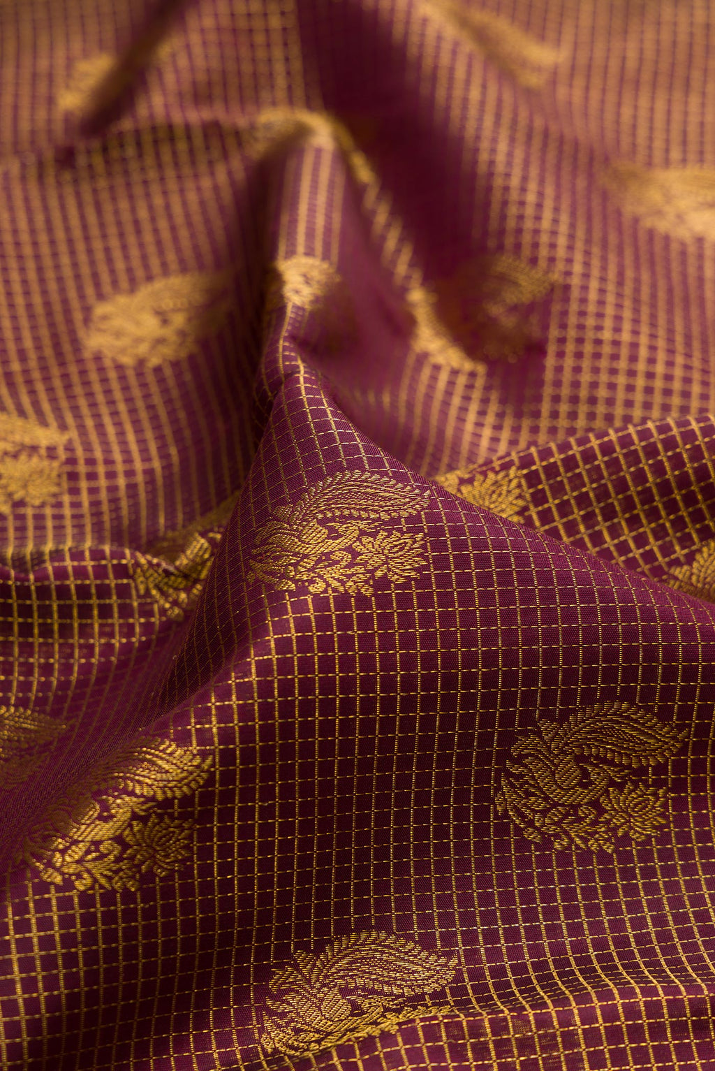 Close up of Pure Silk Brown Kanchipuram Saree with Zari Brocade on the body and Zari Border.  displaying folds