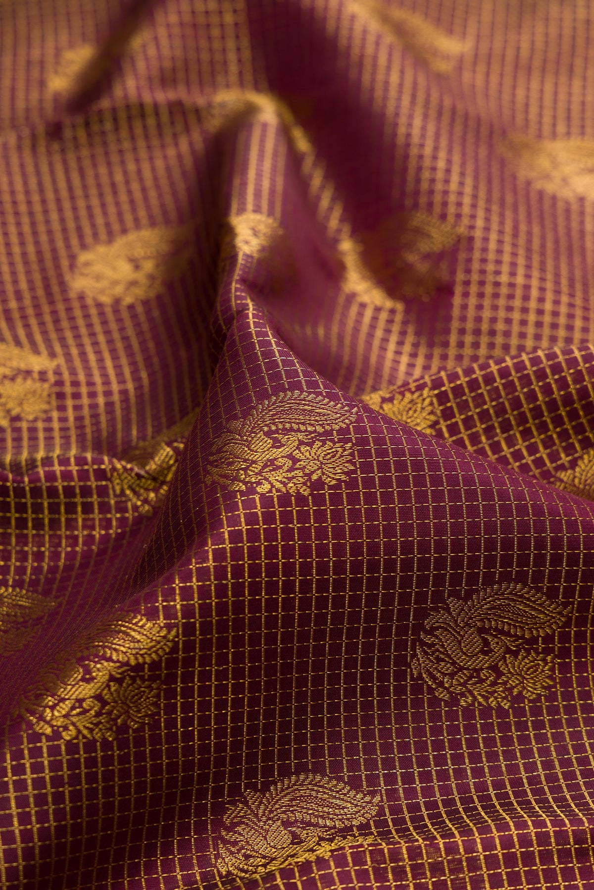 Close up of Pure Silk Brown Kanchipuram Saree with Zari Brocade on the body and Zari Border.  displaying folds