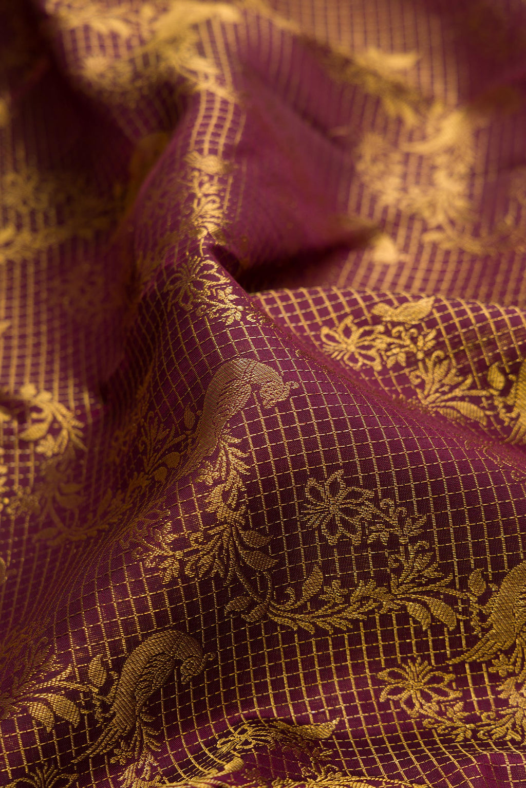 Close up of Pure Silk Maroon Kanchipuram Saree with Zari Brocade on the body and Zari Border.  displaying folds