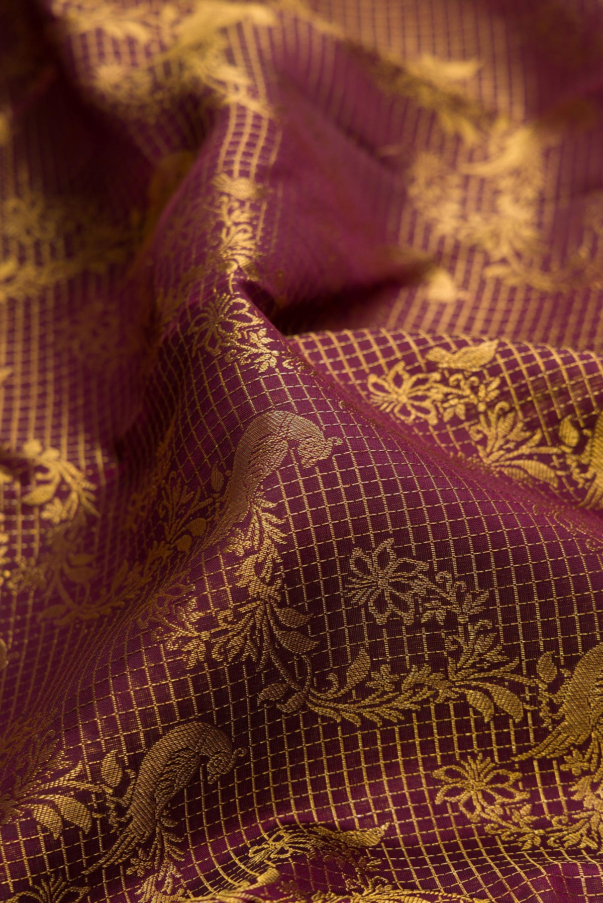 Close up of Pure Silk Maroon Kanchipuram Saree with Zari Brocade on the body and Zari Border.  displaying folds