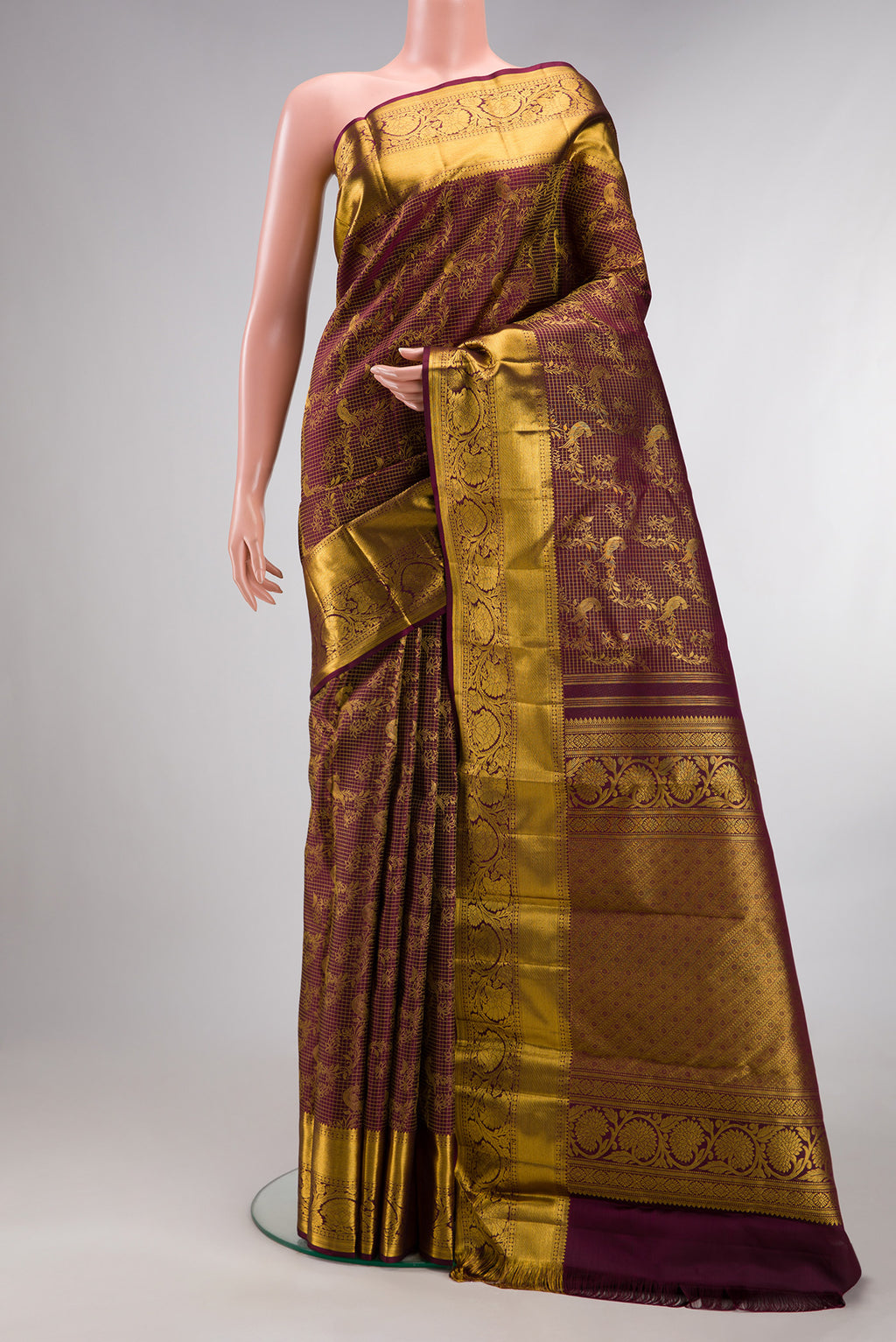 Pure Silk Maroon Kanchipuram Saree with Zari Brocade on the body and Zari Border.  displayed on a mannequin