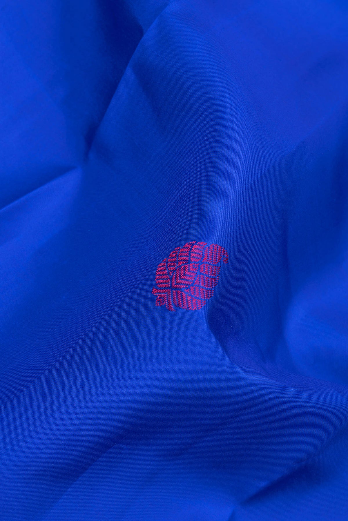 Close up of Pure Silk Royal Blue Kanjivaram Saree with Zari And Thread Butta on the body and Zari Border.  displaying folds