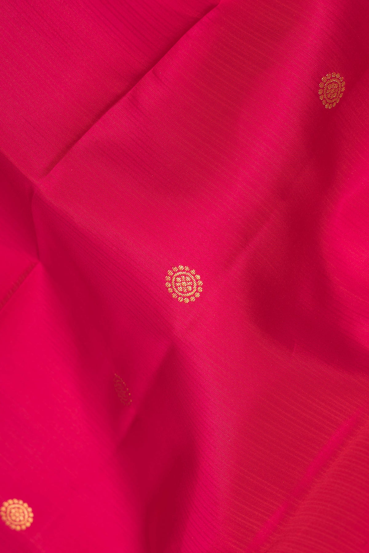 Close up of Pure Silk Pink Dual Tone Kanjivaram Saree with Zari Butta on the body and Zari Border.  displaying folds