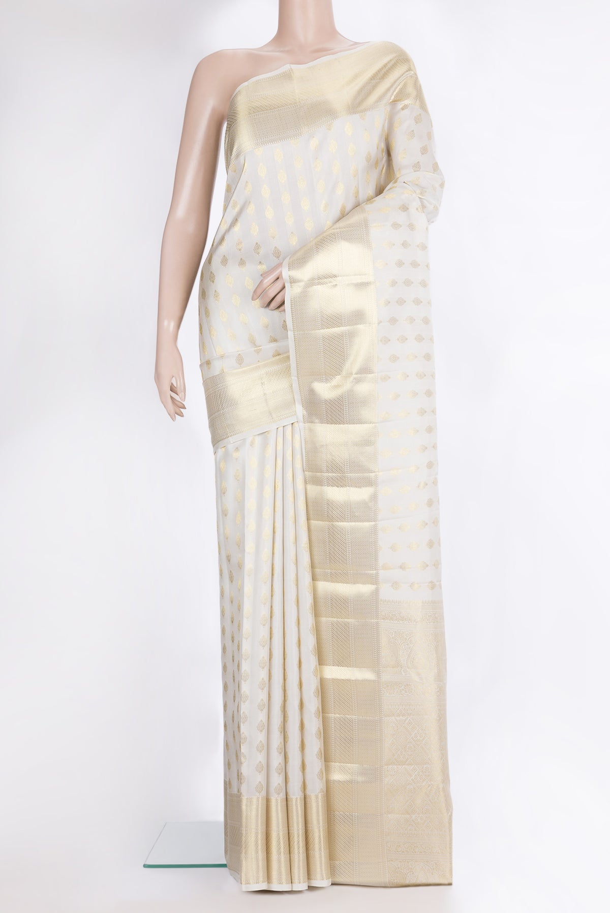 Pure Silk White Kanchipuram Saree with Zari Butta on the body and Zari Border.  displayed on a mannequin
