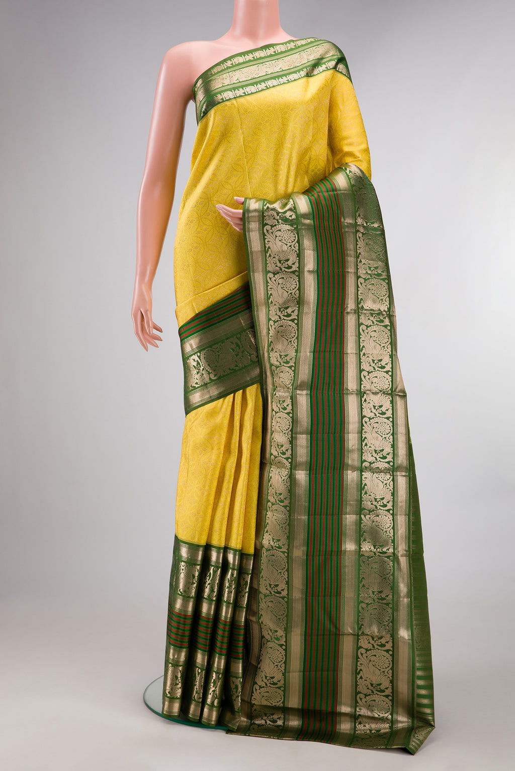 Pure Silk Lemon Yellow Kanchipuram Saree with Zari Brocade on the body and Fancy Border.  displayed on a mannequin