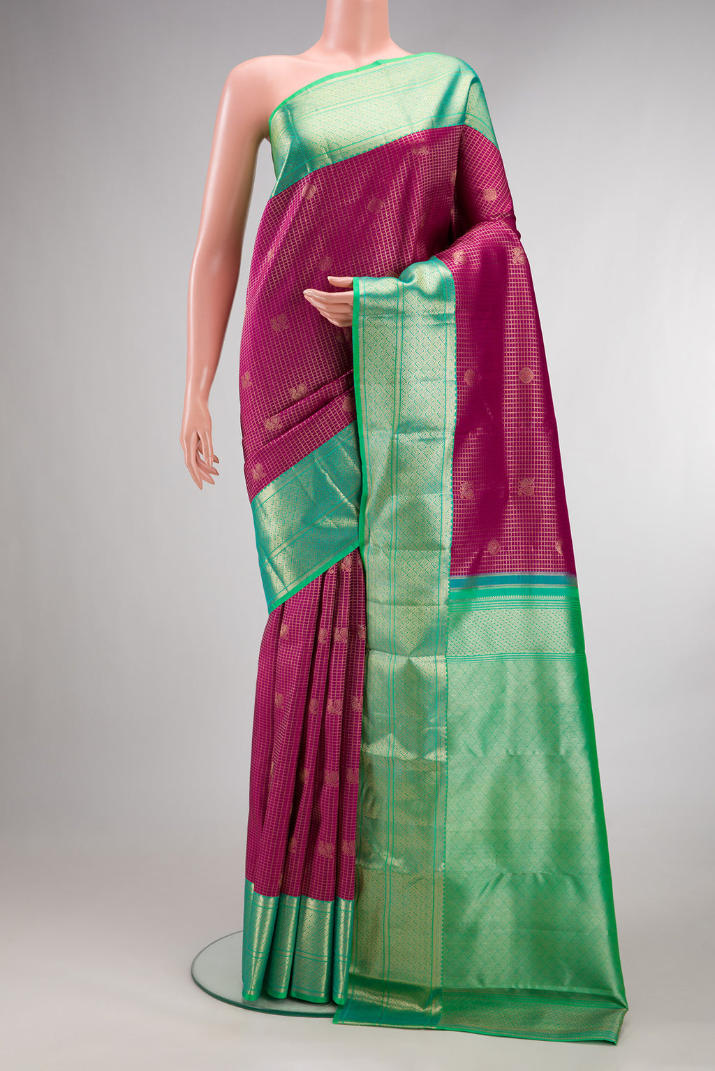 Pure Silk Dark Pink Kanjivaram Saree with Zari Brocade on the body and Zari Border.  displayed on a mannequin
