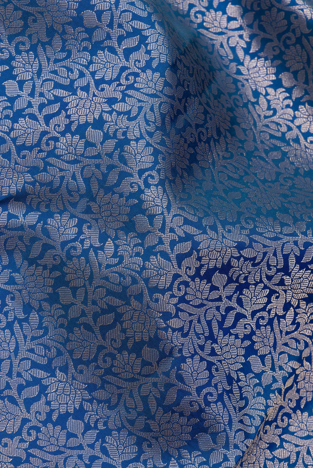 Close up of Pure Silk Peacock Blue Dual Tone Kanchipuram Saree with Zari Brocade on the body and Zari Border.  displaying folds