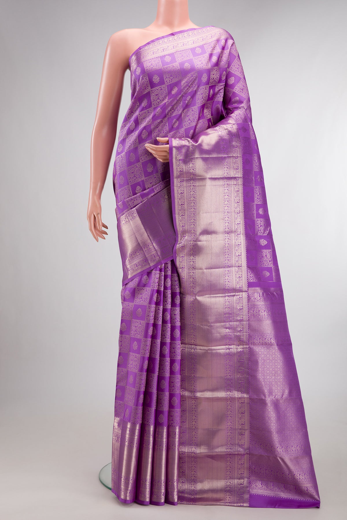 Pure Silk Lavender Kanchipuram Saree with Zari Brocade on the body and Zari Border.  displayed on a mannequin