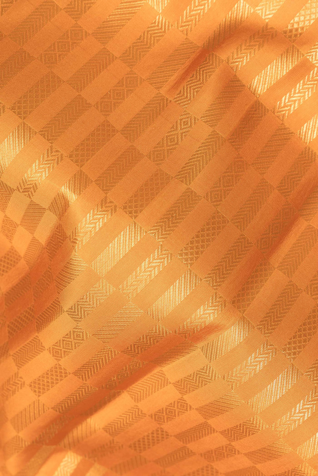 Close up of Pure Silk Mustard Kanjivaram Saree with Zari Brocade on the body and Zari Border.  displaying folds