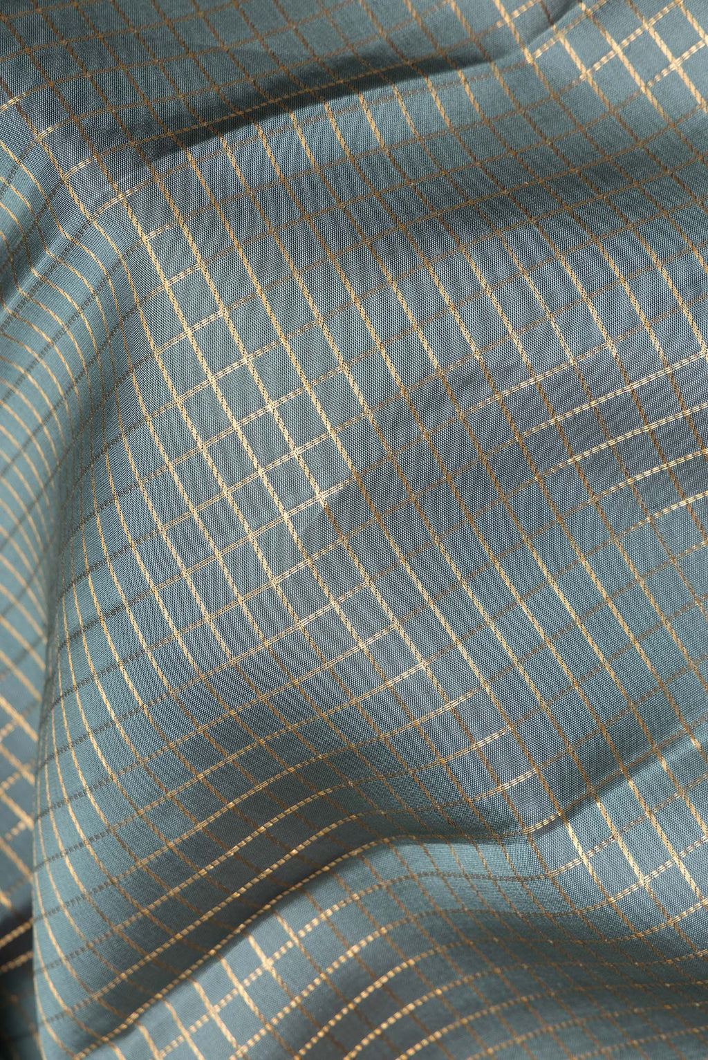 Close up of Pure Silk Grey Kanjivaram Saree with Checked design on the body and Zari Border.  displaying folds