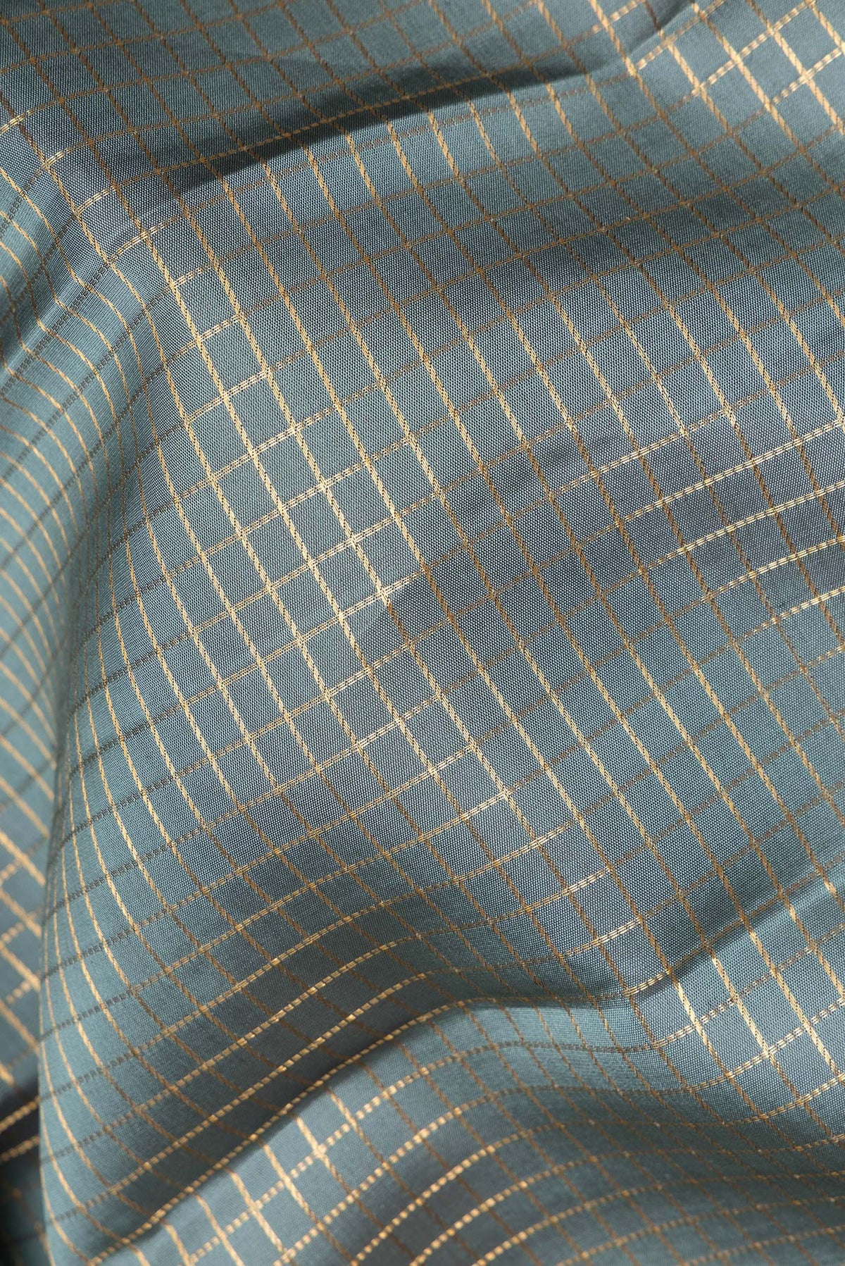 Close up of Pure Silk Grey Kanjivaram Saree with Checked design on the body and Zari Border.  displaying folds