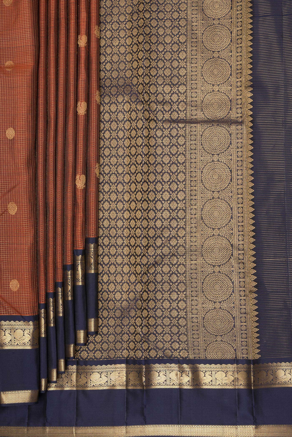 Pleats and pallu of Pure Silk Rust Kanjivaram Saree with Checked design on the body and Zari Border. 