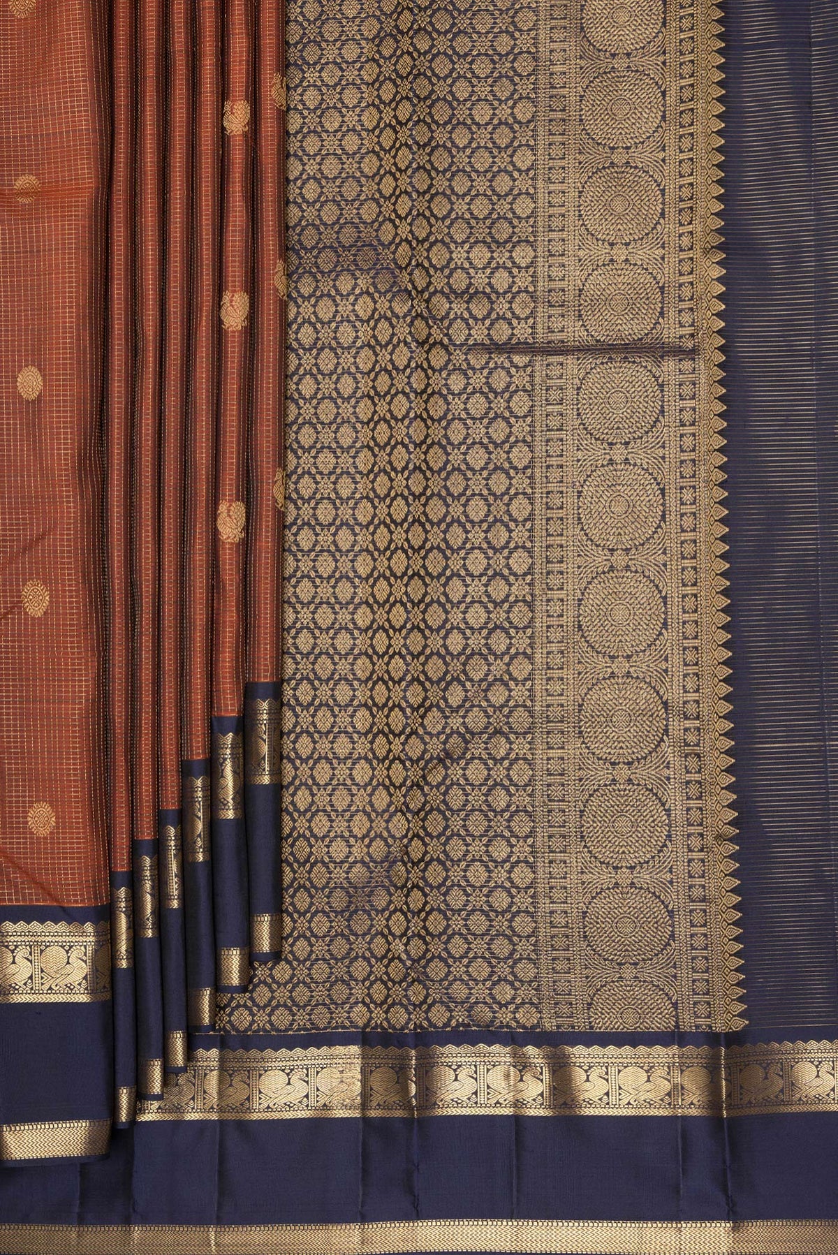 Pleats and pallu of Pure Silk Rust Kanjivaram Saree with Checked design on the body and Zari Border. 