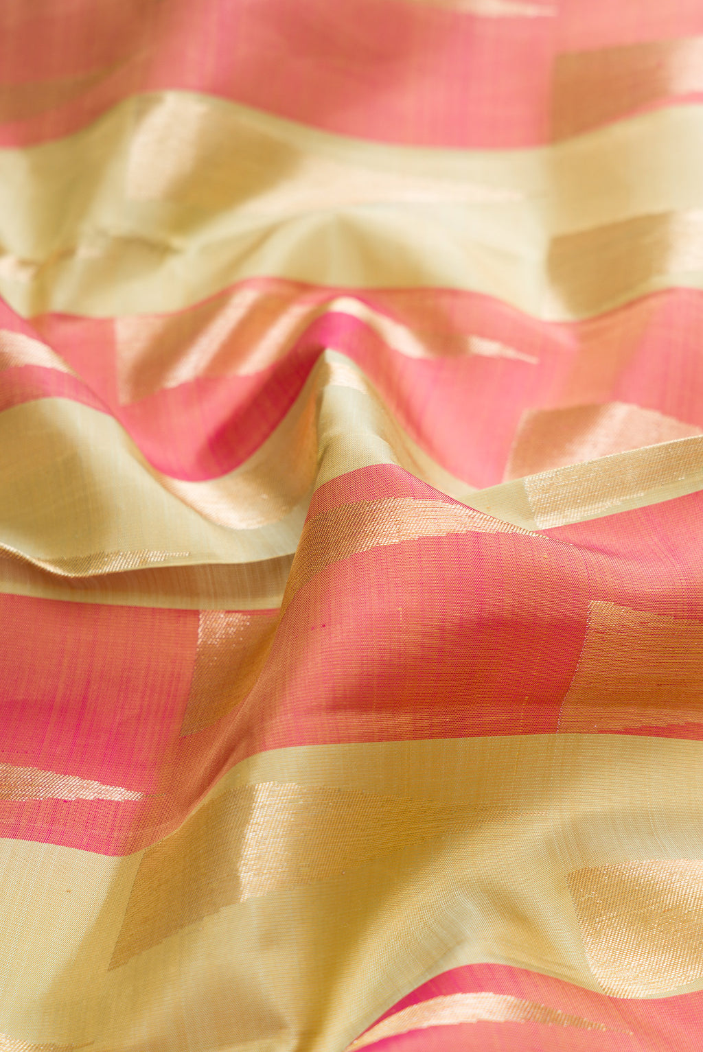 Close up of Pure Silk Coral  and Pista Green Color Kanchipuram Saree with Zari Brocade on the body and Without Border.  displaying folds