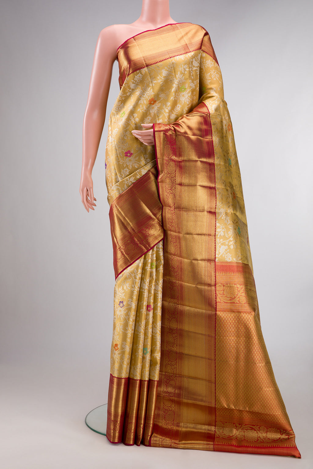 Gold Dual Tone Kanjivaram Tissue Saree with Zari Brocade on the body and Zari Border.  displayed on a mannequin