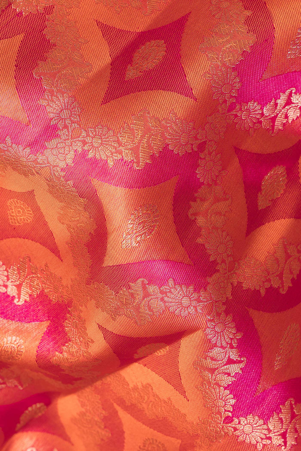 Close up of Pure Silk Orange Dual Tone Kanjivaram Saree with Zari Brocade on the body and Zari Border.  displaying folds