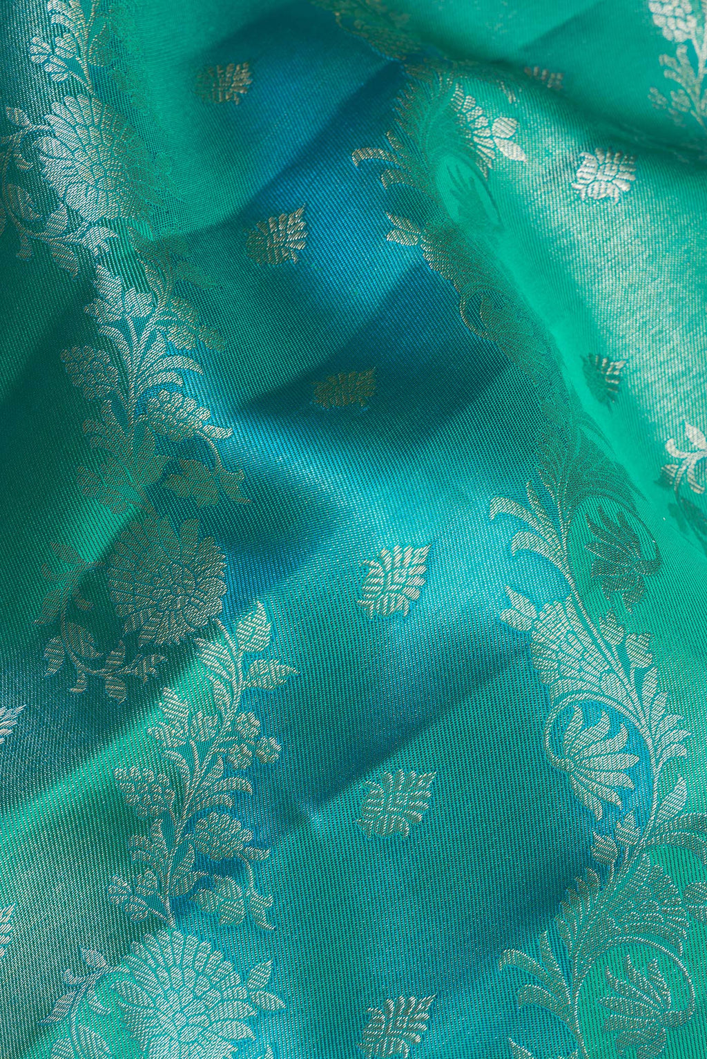 Close up of Pure Silk Sea Green and Sky Blue Color Kanjivaram Saree with Zari Brocade on the body and Fancy Border.  displaying folds