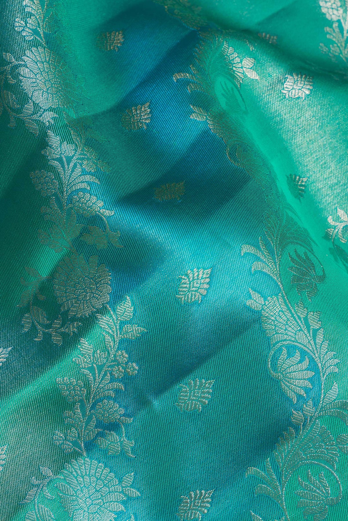 Close up of Pure Silk Sea Green and Sky Blue Color Kanjivaram Saree with Zari Brocade on the body and Fancy Border.  displaying folds