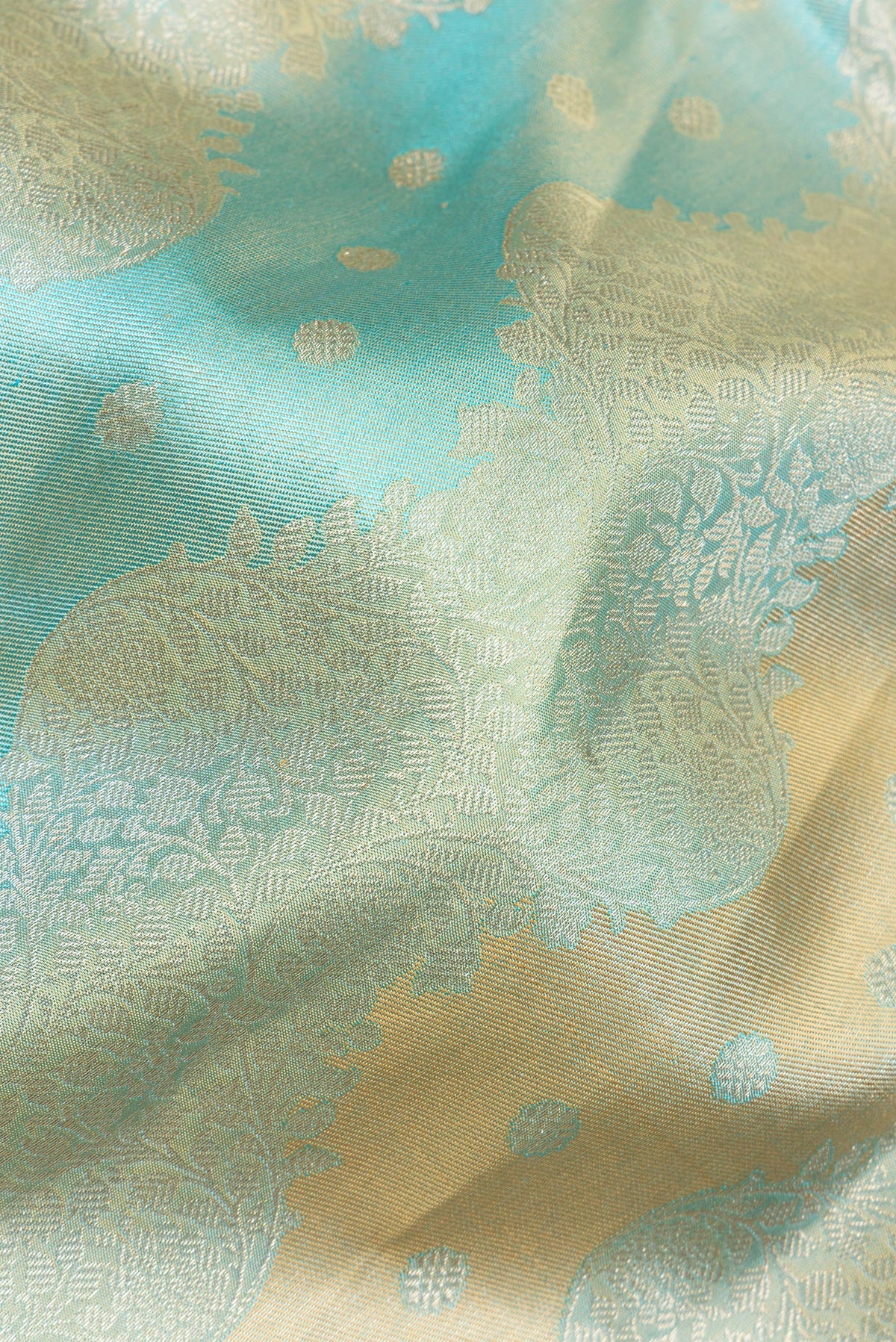 Close up of Pure Silk Sky Blue and Gold Color Kanjivaram Saree with Zari Brocade on the body and Zari Border.  displaying folds