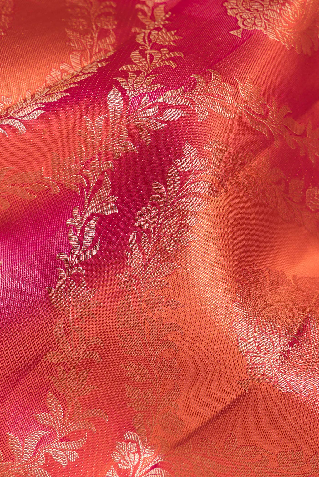 Close up of Pure Silk Orange Dual Tone Kanjivaram Saree with Zari Brocade on the body and Zari Border.  displaying folds