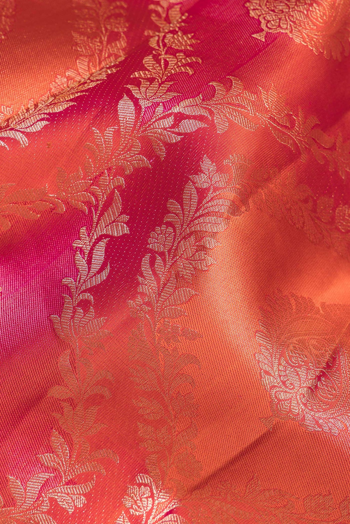 Close up of Pure Silk Orange Dual Tone Kanjivaram Saree with Zari Brocade on the body and Zari Border.  displaying folds