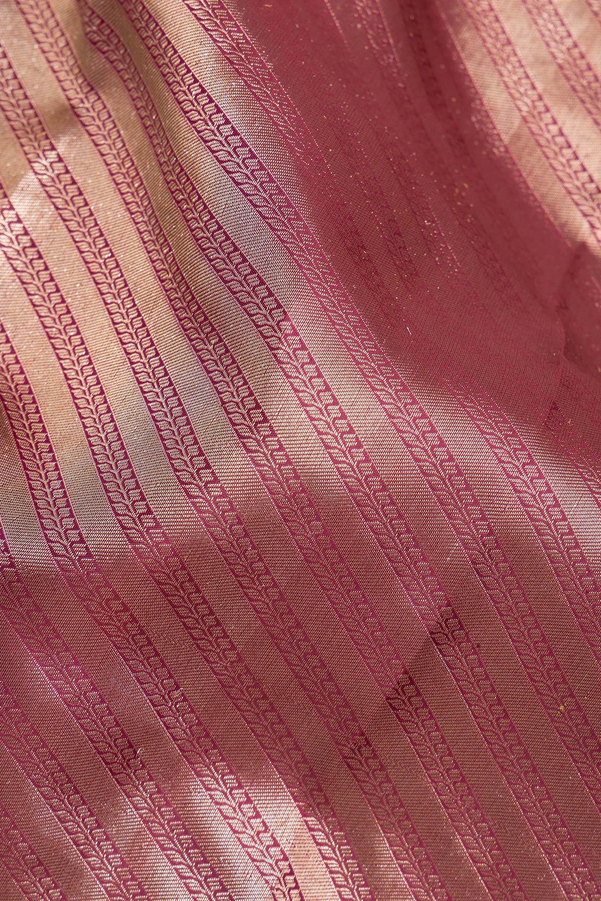 Close up of Pure Silk Maroon Kanjivaram Saree with Zari Brocade on the body and Fancy Border.  displaying folds