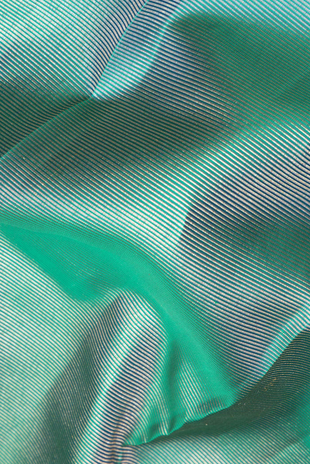 Close up of Pure Silk Green Dual Tone Kanjivaram Saree with Zari Brocade on the body and Fancy Border.  displaying folds