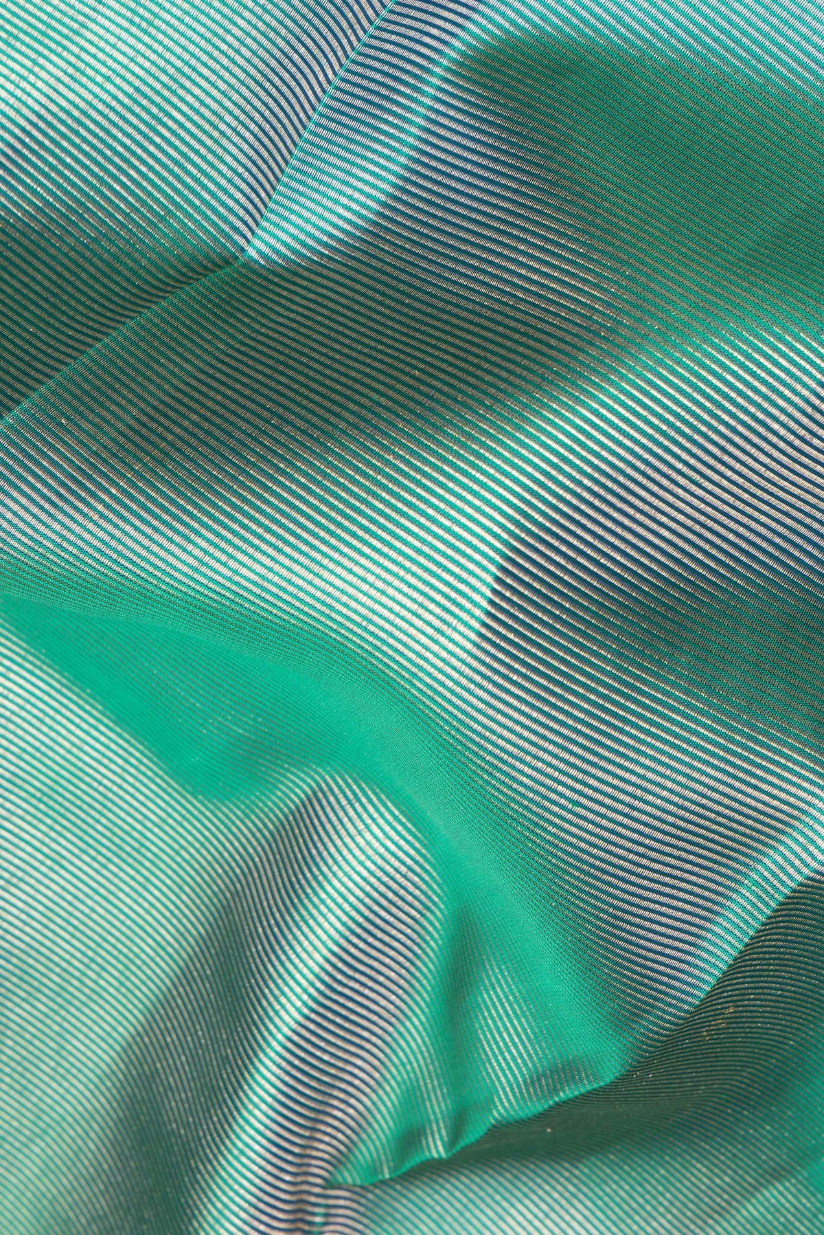 Close up of Pure Silk Green Dual Tone Kanjivaram Saree with Zari Brocade on the body and Fancy Border.  displaying folds