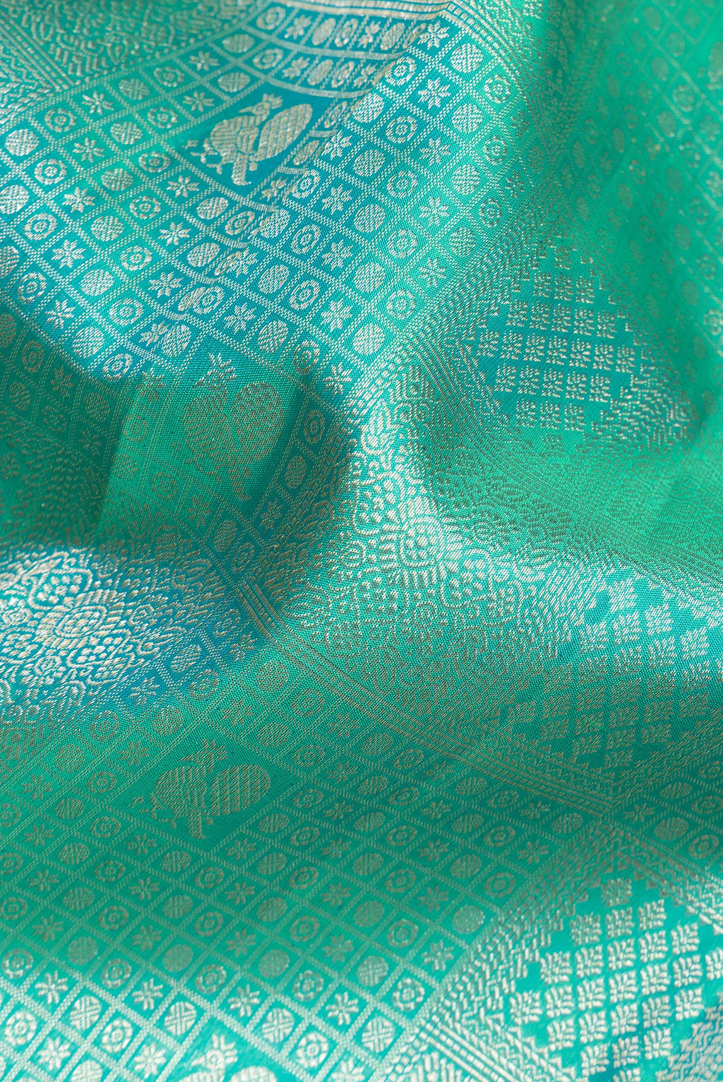 Close up of Pure Silk Sea Green Dual Tone Kanjivaram Saree with Zari Brocade on the body and Zari Border.  displaying folds