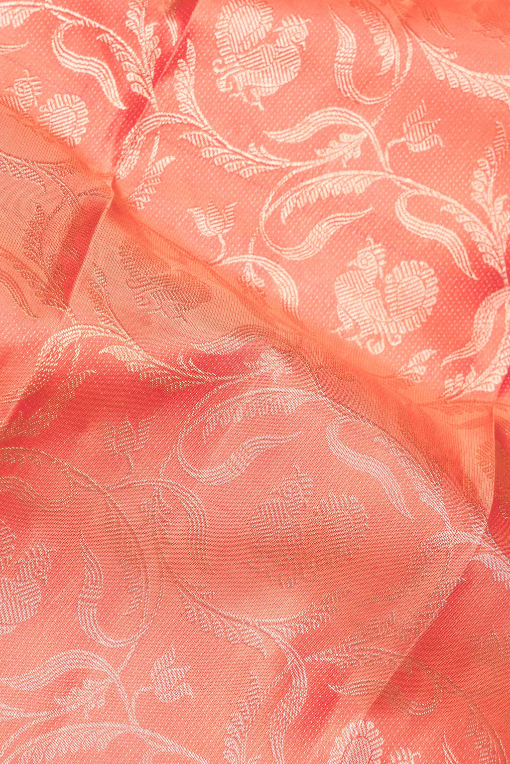 Close up of Pure Silk Peach Dual Tone Kanjivaram Saree with Zari Brocade on the body and Fancy Border.  displaying folds