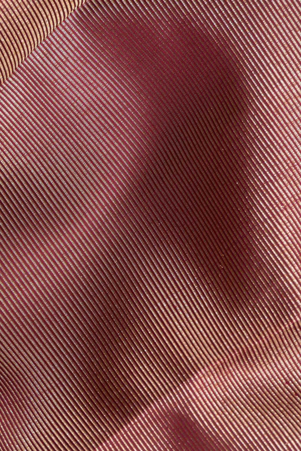 Close up of Pure Silk Maroon Kanjivaram Saree with Zari Brocade on the body and Fancy Border.  displaying folds