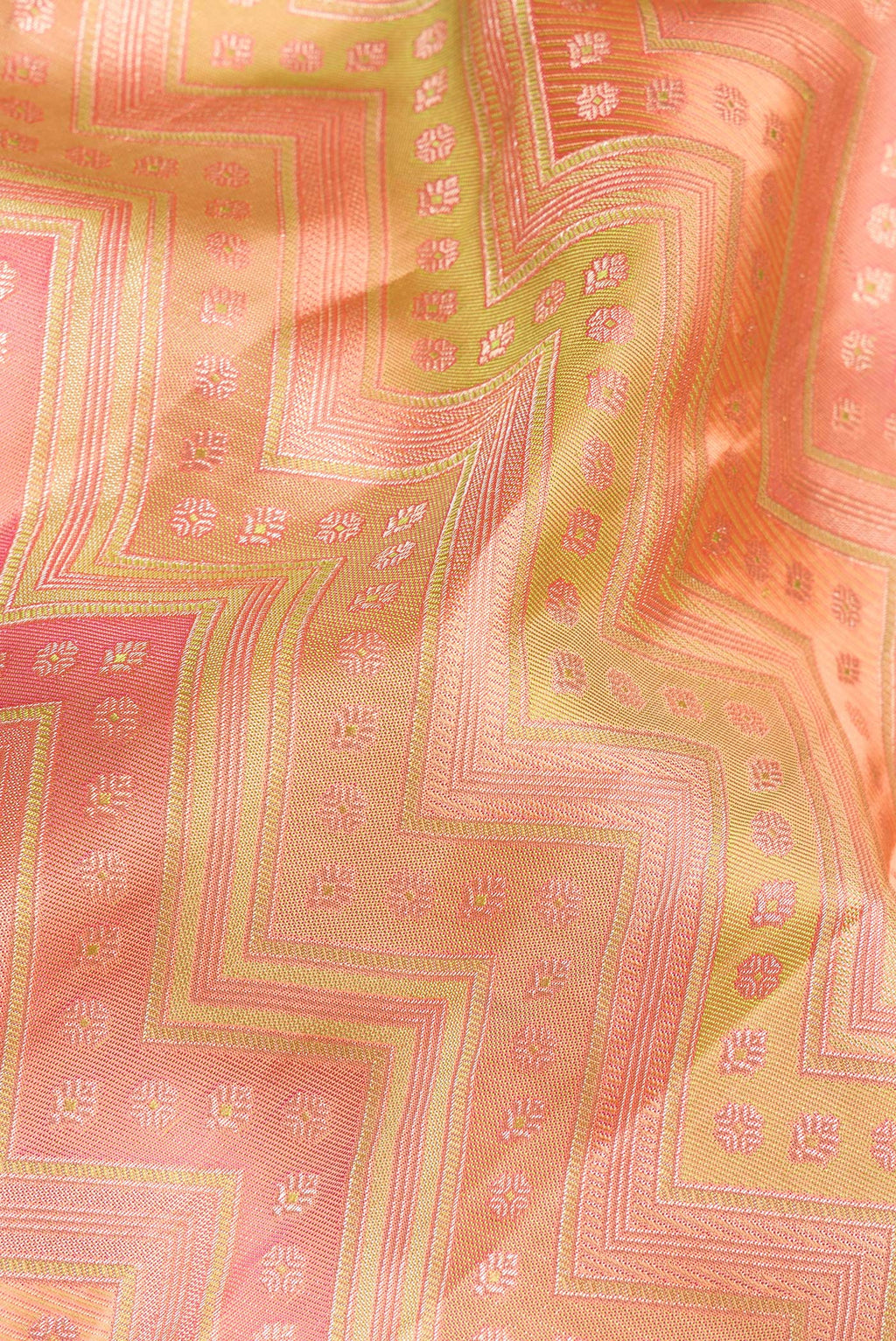 Close up of Pure Silk Golden Peach Dual Tone Kanjivaram Saree with Zari Brocade on the body and Zari Border.  displaying folds