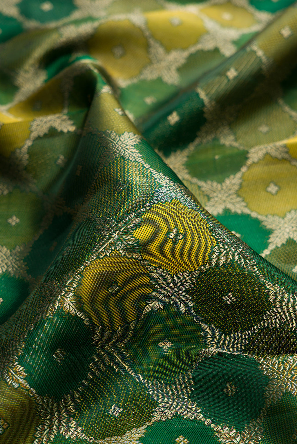 Close up of Pure Silk Bottle Green Kanjivaram Saree with Zari Brocade on the body and Zari Border.  displaying folds